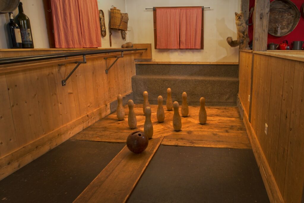 A bowling alley with bowling pins and a bowling ball