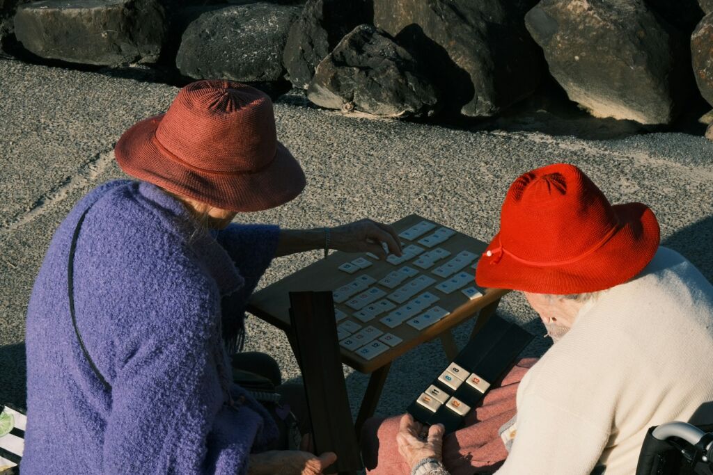 Two people in hats looking at a board