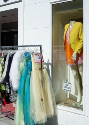 a display of clothes in a window of a clothing store