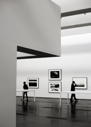 woman in black tank top and black pants standing on black wooden seat