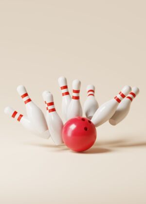 a red bowling ball crashing into the pins