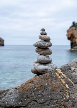 Stack of balanced stones on a rocky shore
