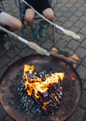 a person sitting in a chair next to a fire pit