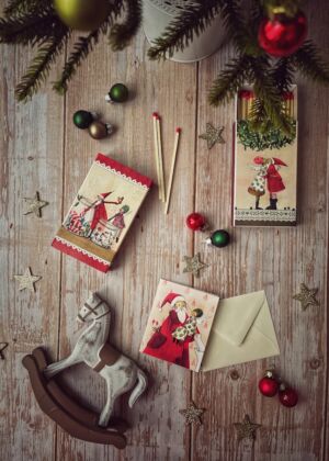 white and red gift box on white wooden table