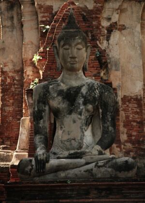 a statue of a person sitting on a bench