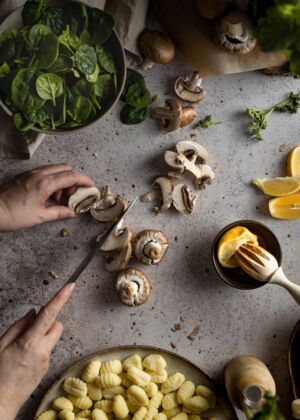 person holding stainless steel spoon with sliced lemon