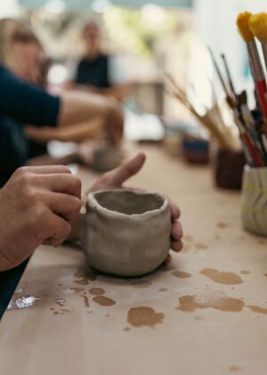 A person sitting at a table with a cup in front of them