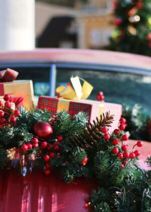 green and red wreath on red car